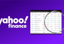 Yahoo Finance logo next to tablet with trending stocks list on it with magnifying glass over top on purple background.