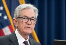 Close up shot of Federal Reserve Chairman Jerome Powell in front of an American flag.