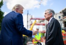 President Trump and Fed Chair Powell at construction site.