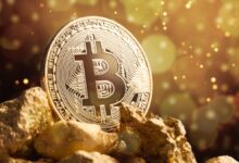 Bitcoin sitting on top of a pile of gold nuggets.