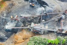 Heavy equipment and trucks operating at lithium mine.