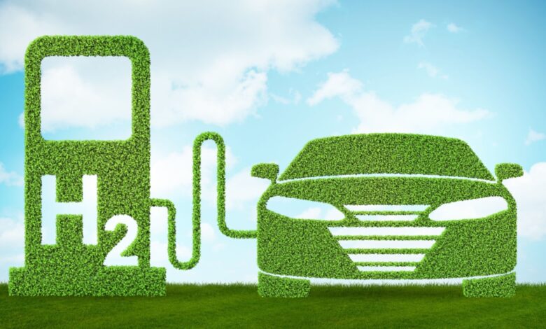 Green hydrogen fuel station and eco-friendly car made of foliage under a blue sky with clouds, symbolizing sustainable transportation, hydrogen-powered vehicles, clean energy alternatives, and zero-emission automotive technology.