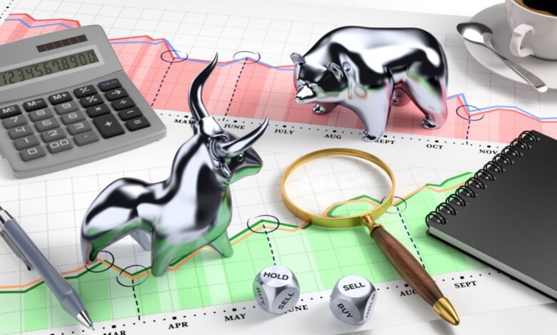 Stock market analysis scene with metallic bull and bear figurines on a financial chart, surrounded by calculator, magnifying glass, dice showing buy-sell-hold options, notebook, pen, and coffee cup, symbolizing bullish and bearish trends, trading strategy, and market forecasting.