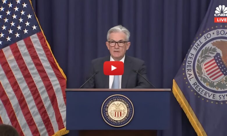 Screenshot from YouTube video of Federal Reserve Chair delivering a live speech at a press conference with U.S. flag and Federal Reserve System seal, broadcast by CNBC.