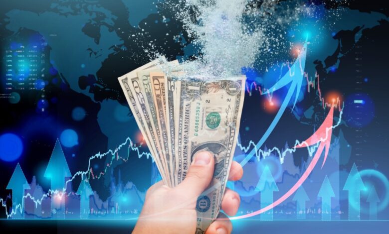 Hand holding dissolving US dollar bills with financial charts and global market arrows, symbolizing stagflation, inflation, currency devaluation, and economic volatility.