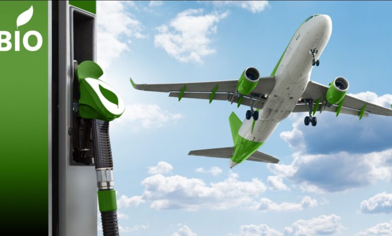Airplane flying in sky over green sustainable fuel pump.