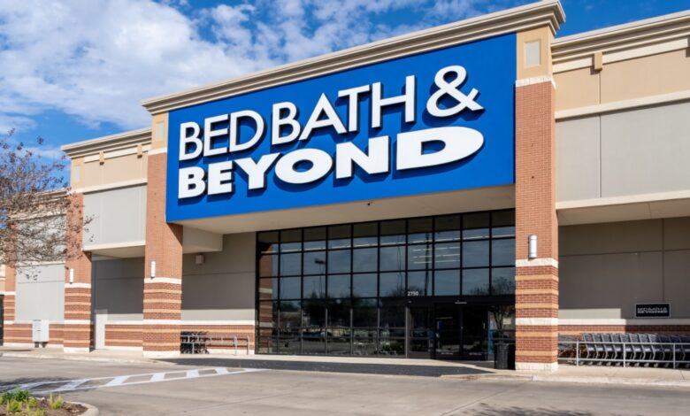 Exterior view of a Bed Bath & Beyond retail store with prominent blue and white signage, showcasing the front entrance and shopping carts, symbolizing home goods retail business and store brand presence.