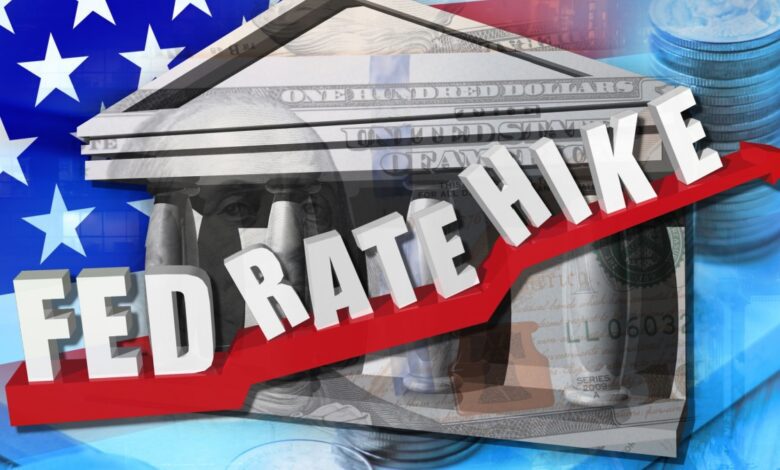 Fed rate hike sign with red up arrow in front of animated Federal Reserve building.