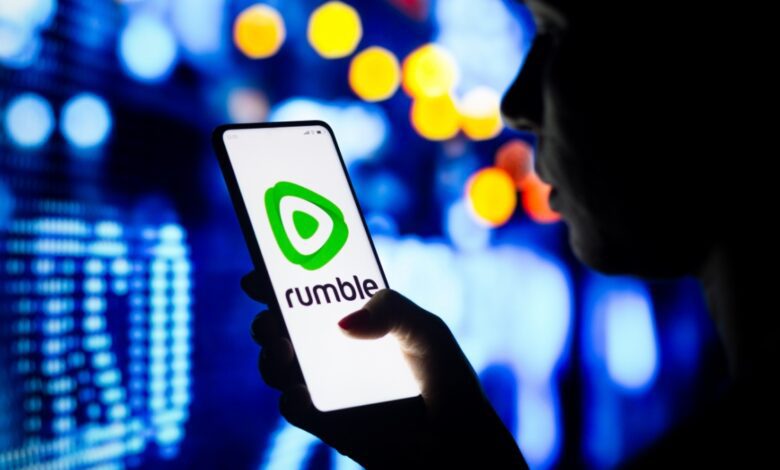 Person scrolls on Rumble app on smartphone.