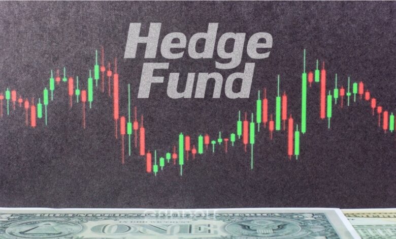 A chart with green and red candlesticks is shown in front of the words Hedge Fund, with part of a U.S. one-dollar bill visible at the bottom of the image.