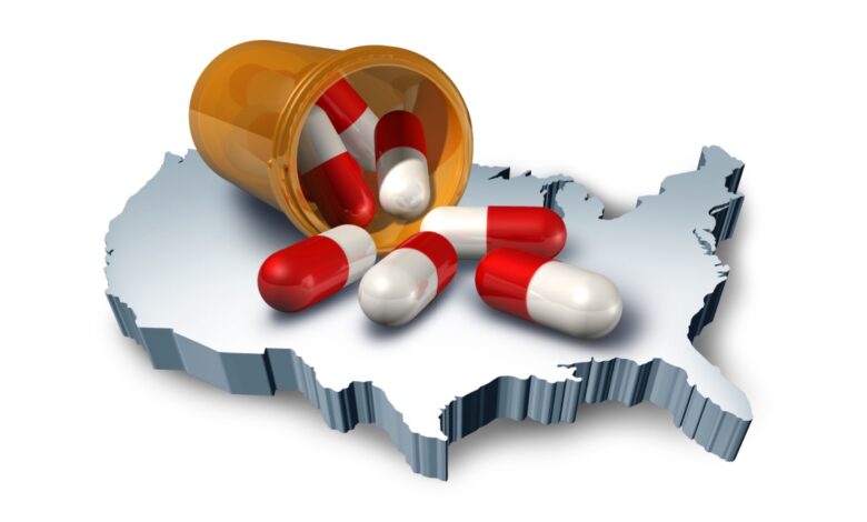 Red and white prescription capsules spilling from an orange pill bottle onto a 3D map of the United States, symbolizing the American healthcare system, pharmaceutical industry, opioid crisis, prescription drug costs, and nationwide medication use.