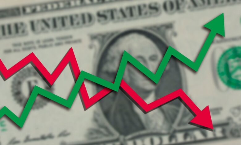 U.S. dollar with green up and red down arrows.