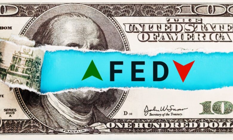 Ripped dollar bill with green up and red down arrows beneath.