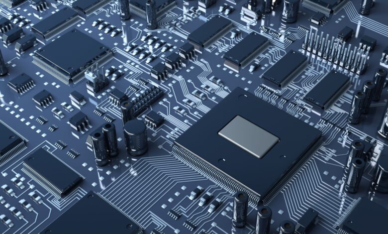 Close up view of a computer circuit board showing its various chips and other parts.