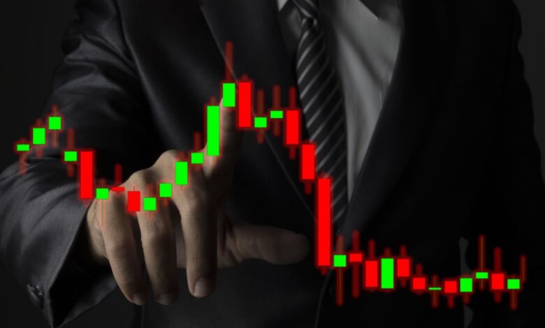 Businessman in a dark suit and striped tie interacting with a virtual candlestick stock chart featuring green and red bars, symbolizing market analysis, financial trading decisions, investment strategy, and stock price fluctuations in a digital trading environment.