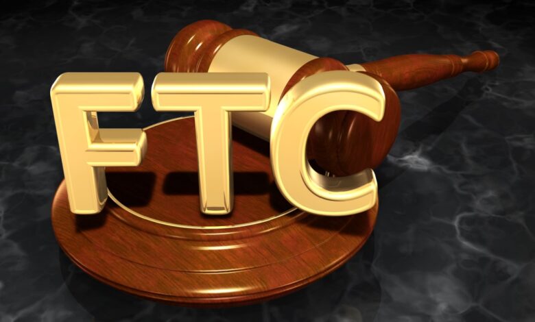 Golden FTC letters in front of a wooden gavel, symbolizing Federal Trade Commission authority and legal regulation in commerce.