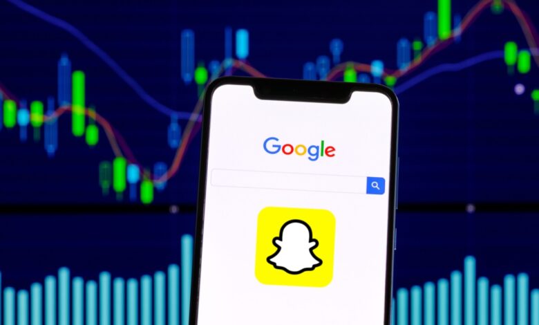 Smartphone displaying Google search and Snapchat logo in front of stock market chart, representing tech stocks and digital advertising trends.