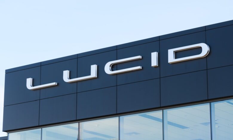 Lucid Motors dealership exterior with modern black facade and large chrome Lucid logo, representing electric vehicle innovation, luxury EV brand presence, and automotive retail architecture under a clear blue sky.