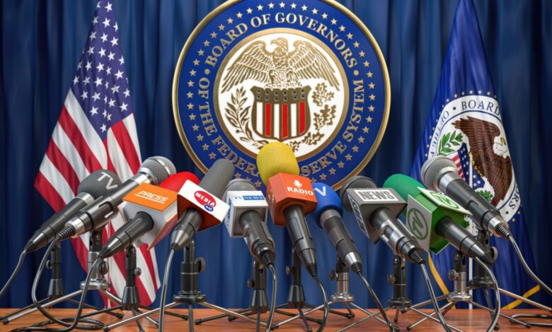 Many media microphones sit on Federal Reserve press conference podium awaiting the speaker.