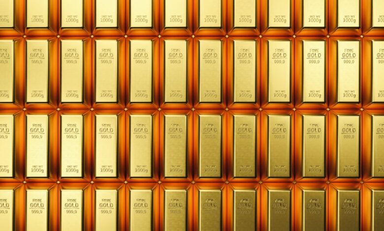 Stacked rows of shiny gold bars each marked with 'FINE GOLD 999.9' and 'NET WT 1000g', symbolizing wealth, precious metal investment and gold bullion reserves.