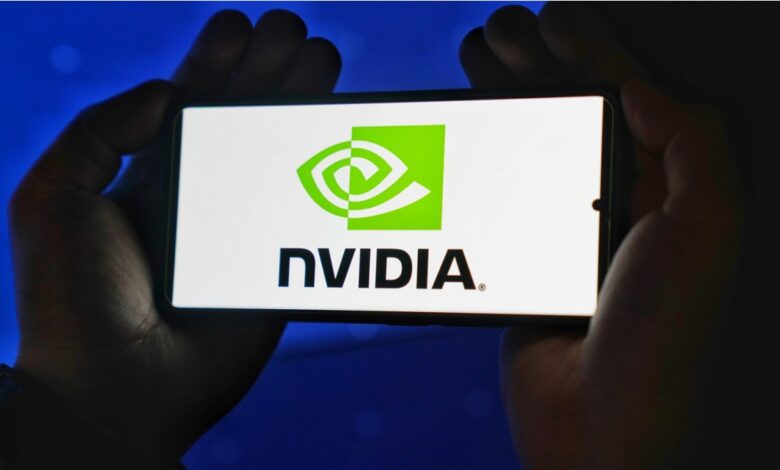 Person holding smartphone with Nvidia logo on it.