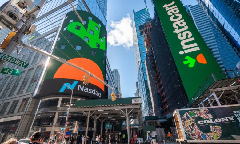 Instacart IPO launch displayed on Nasdaq digital billboards in Times Square, New York City, showcasing the grocery delivery company's public market debut.