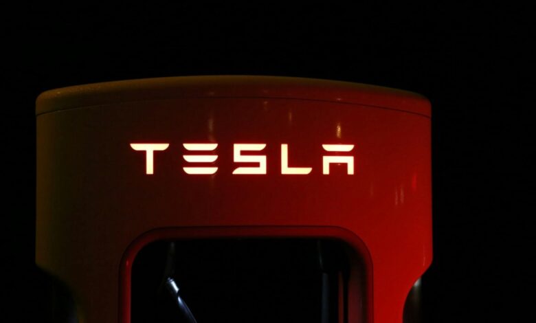 Red Tesla electric vehicle charging station.