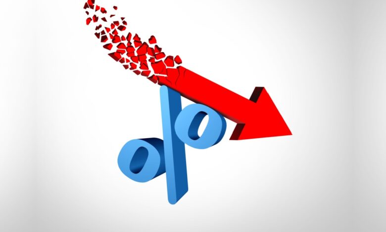 Red downward arrow shattering through a blue percent symbol, representing falling interest rates, economic decline, or reduced financial returns.