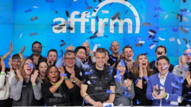 A group of Affirm Holdings management and investors cheering while ringing the NASDAQ opening bell, with confetti steaming down from above.