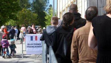 French voters stand in line at a polling station, waiting to cast their votes in France's 2017 Presidential election.