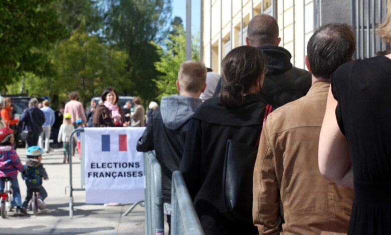 French voters stand in line at a polling station, waiting to cast their votes in France's 2017 Presidential election.