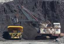 Peabody Energy coal mining excavator dumps freshly mined coal into the back of an extra large yellow haul truck.