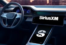 White Sirius XM logo is boldly displayed on an extra large black stereo touch screen on the dashboard of a car.
