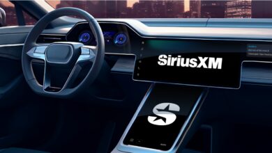 White Sirius XM logo is boldly displayed on an extra large black stereo touch screen on the dashboard of a car.