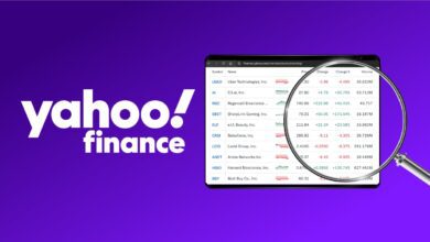 Yahoo Finance logo next to tablet with trending stocks list on it with magnifying glass over top on purple background.
