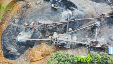 Heavy equipment and trucks operating at lithium mine.