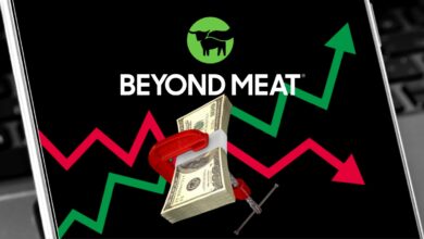 Beyond Meat logo with up and down stock chart arrows on smartphone background.