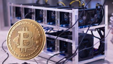 Bitcoin coin in front of Bitcoin mining rig.