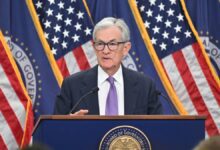 Federal Reserve Chairman Jerome Powell stands behind podium at press conference.
