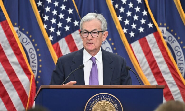 Federal Reserve Chairman Jerome Powell stands behind podium at press conference.