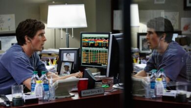 Actor Christian Bale sits behind a desk looking at stock trading computers when he played the character of Michael Burry in the movie The Big Short.