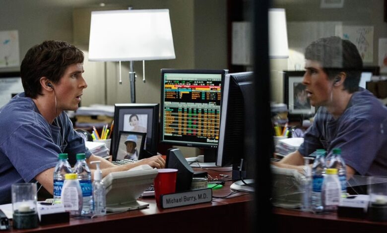 Actor Christian Bale sits behind a desk looking at stock trading computers when he played the character of Michael Burry in the movie The Big Short.
